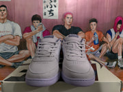 Front view of purple and gray lace-up sneakers showing the perforated toe boxes and padded tongues.