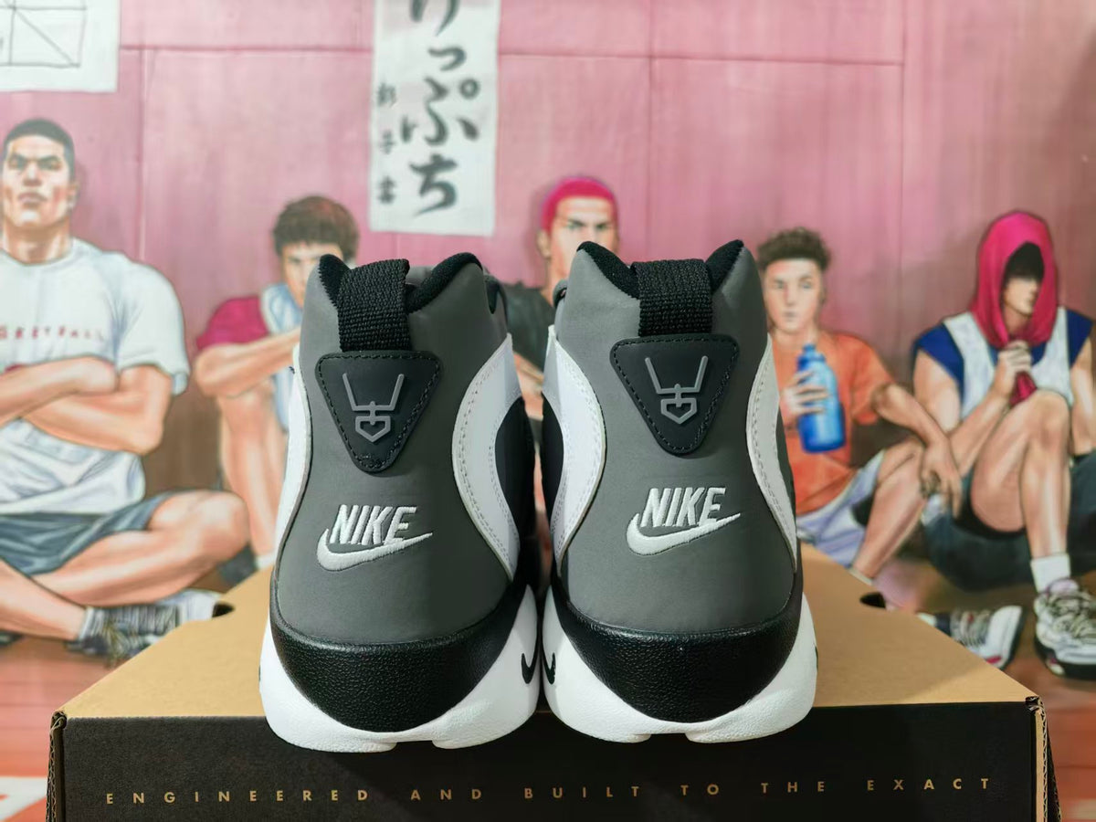 Rear view of gray and blue Nike high-top sneakers showing heel branding, white accents, and black-and-white soles.