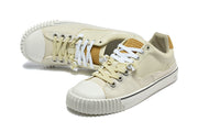 Cream low-top sneakers shown from above, highlighting the lace contrast and ribbed toe bumpers.