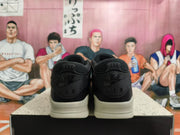 Rear view of black and cream low-top sneakers with Nike Air heel branding