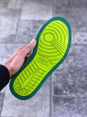 Close-up of the bright green patterned outsole and circular traction design.