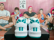 Rear view of the sneakers showing green heel accents, white padding, and textured white midsoles.