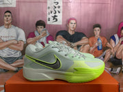 Side view of gray-green Nike basketball shoes with a black Swoosh outlined in bright green