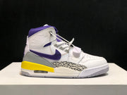 Single sneaker in side profile with white upper, purple collar and branding, yellow heel section, and patterned side panel.