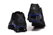 Rear view of black Nike Shox TL sneakers showing blue accents and the sculpted sole.