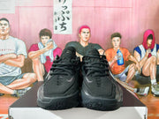 Front view of a pair of black Nike GT basketball sneakers with silver details.