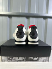Rear view of the pair showing black heel panels, embossed branding, and red collar lining.
