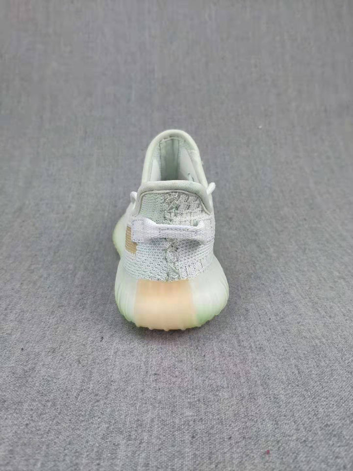 Rear view of a pale gray kids' sneaker with a padded collar and translucent-looking sole.