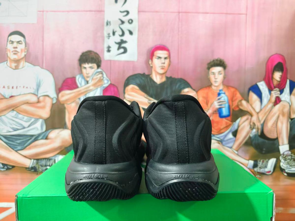 Rear view of black Nike sneakers showing padded collars and textured outsole.
