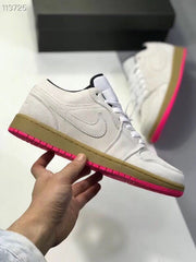 Side profile showing the low-top silhouette, gray upper, gum-colored midsole, and bright pink outsole.