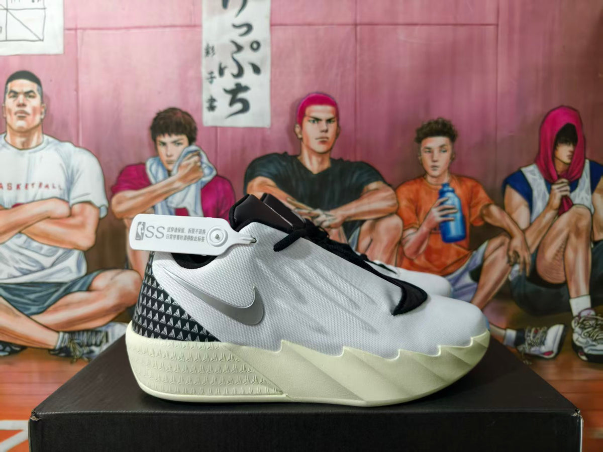 Side view of a white basketball shoe with gray side detail, black patterned heel, and pale sculpted outsole