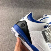 Detailed view of the heel and side panel with black and blue accents, visible air unit, and printed sidewall text.