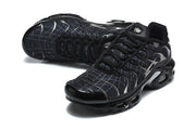 Angled top view of black grid-pattern sneakers with lace-up closure