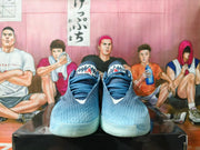 Front view of blue Nike LeBron basketball shoes showing the tongue branding and textured uppers.