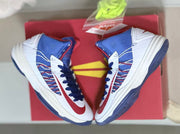 Pair of shoes displayed on a red box with bright spare laces