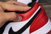 Close-up of red heel, white trim, and black Swoosh detailing.