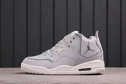 Side profile showing the metallic Jumpman logo, layered panels, laces, and outsole.