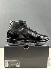 Black high-top sneaker displayed on its box with a visible label identifying Air Jordan 11 CDG SP, style code LV7639-001, and EU 40 sample sizing.