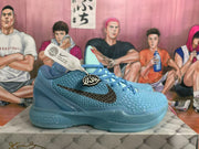Side profile of a blue Nike basketball sneaker showing the raised-pattern upper, black Swoosh, and sculpted blue sole.