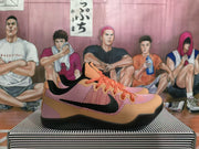 Side view of a Nike basketball sneaker showing the black Swoosh, textured upper, orange accents, and black rubber outsole.