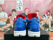 Rear view showing the blue heels, red collar lining, white outsoles, and the number 24 embossed on both shoes.