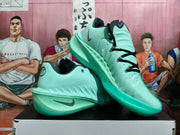 Pair of lake-green Nike basketball shoes with black laces and dark Swoosh accents