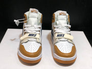 Front view of the pair showing perforated white toe boxes, tan toe overlays, white laces, and adjustable straps.