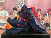 Pair of navy basketball shoes with red laces, orange-yellow accents, and visible side Swooshes.
