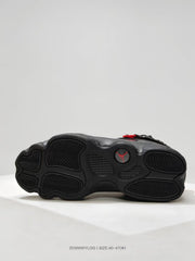 Black sneaker outsole showing a segmented tread pattern and red Jordan emblem.