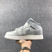 Opposite side profile showing the high-top collar, grey overlays, laces, and side Swoosh.