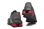 Rear and outsole views of gray Nike Shox Ride 2 sneakers with red heel cushioning columns.