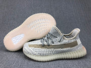Side view with the outsole visible, showing its translucent construction and patterned tread.