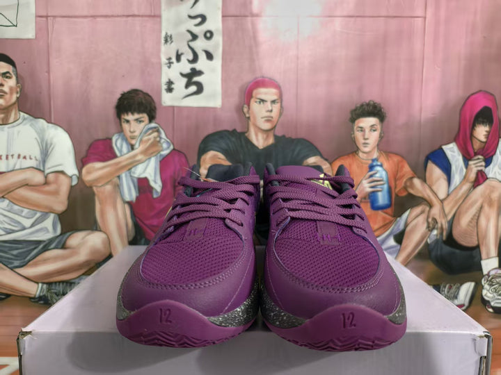 Front view of purple Nike basketball sneakers showing the laces, textured toe boxes, and speckled midsole accents.