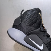 Close-up side view showing the textured high-top collar, lace area, side Swoosh, and grey midsole.