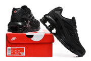 Black Nike Shox Ride 2 sneakers displayed with a red shoebox; the box label shows a sample size of US men's 8.5 and US women's 10.