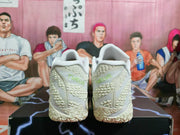 Rear view of a pair of white Nike basketball sneakers showing textured heels and visible Sabrina markings.