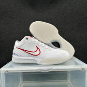 Pair of white basketball sneakers showing the red side branding and translucent textured outsole.