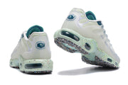 Rear and underside views of the white and teal Nike Air Max Tn sneakers.