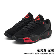 Pair of black Jordan 8812 basketball shoes with red accents and textured side panels.