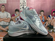 Angled view of light blue Nike basketball shoes showing the side logo, laces, and layered sole.