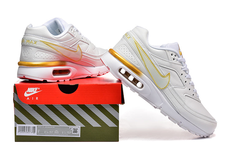 White and gold Nike Air Max sneakers shown with a shoe box.