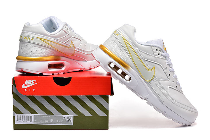 White and gold Nike Air Max sneakers shown with a shoe box.