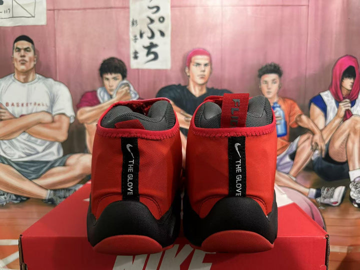 Rear view of red and black Nike high-top basketball shoes with heel pull tabs.
