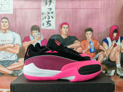 Side view of a black and pink Jordan basketball sneaker with patterned mesh panels and a white midsole section.