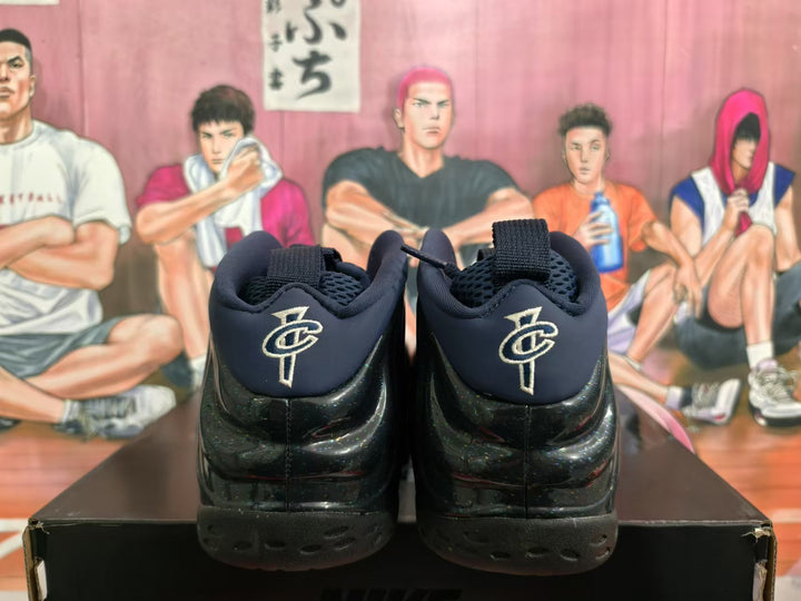Rear view of black and navy Nike basketball sneakers showing padded collars, heel branding and textured outsoles.