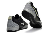 Black and gray Nike Ja 2 shoes shown from rear and outsole angles