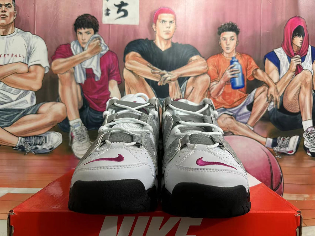 Front view of white and grey Nike basketball sneakers with burgundy accents