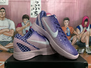 Angled view of the pair highlighting the purple gradient finish, checkerboard panels and light-colored Swooshes.