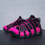 Pair of black and pink Nike Air More Uptempo sneakers at an angle