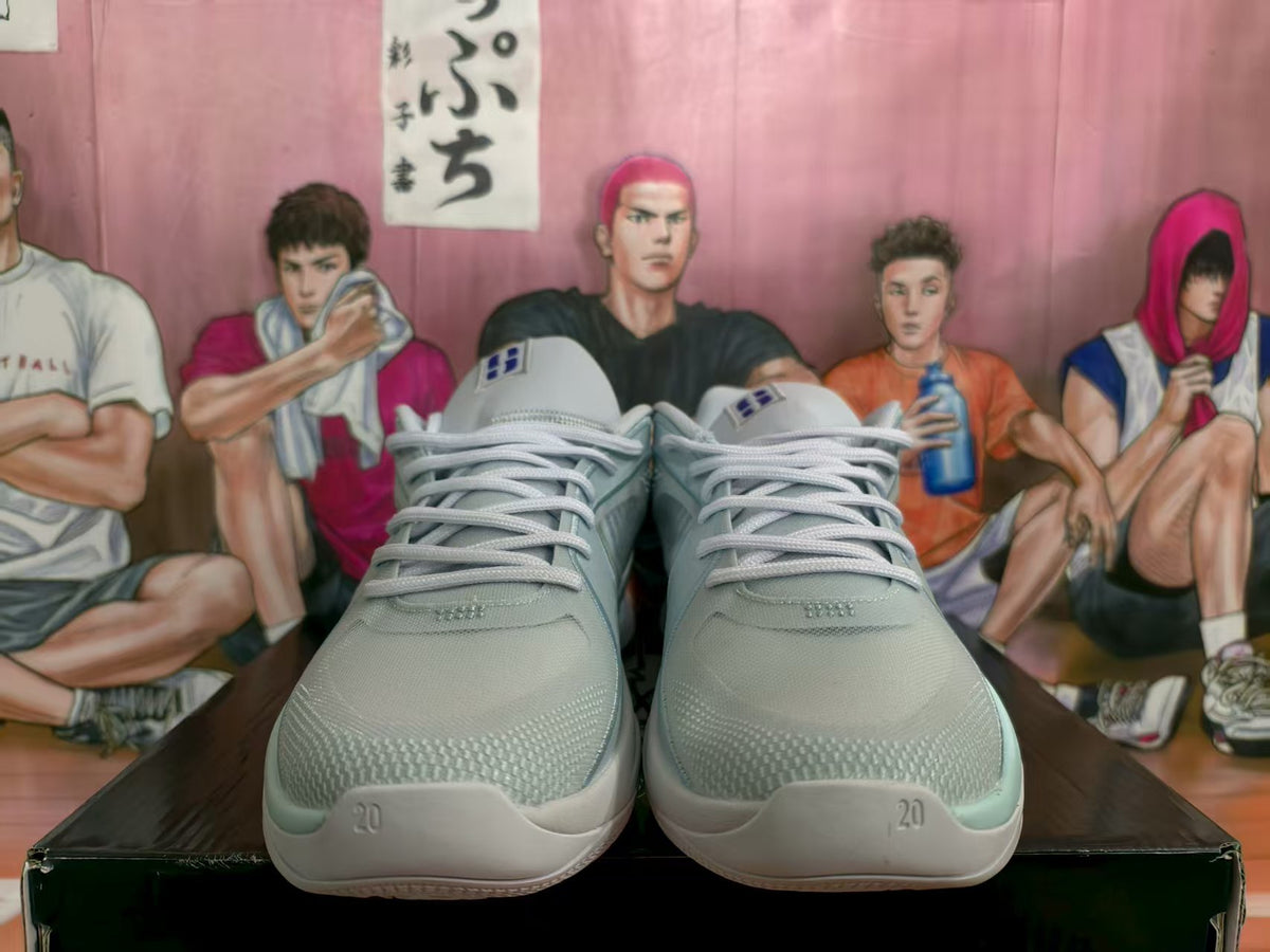 Front view of white and gray Nike basketball sneakers with pale blue accents and white laces.